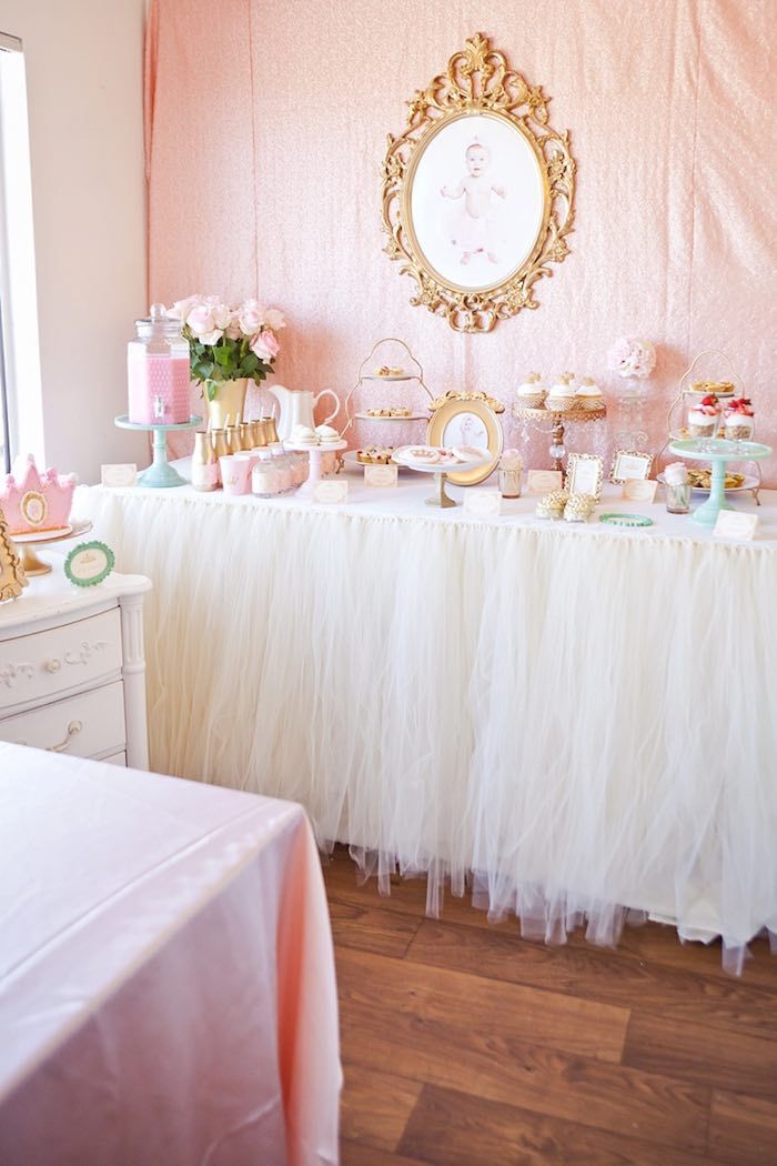 a table topped with lots of cakes and cupcakes