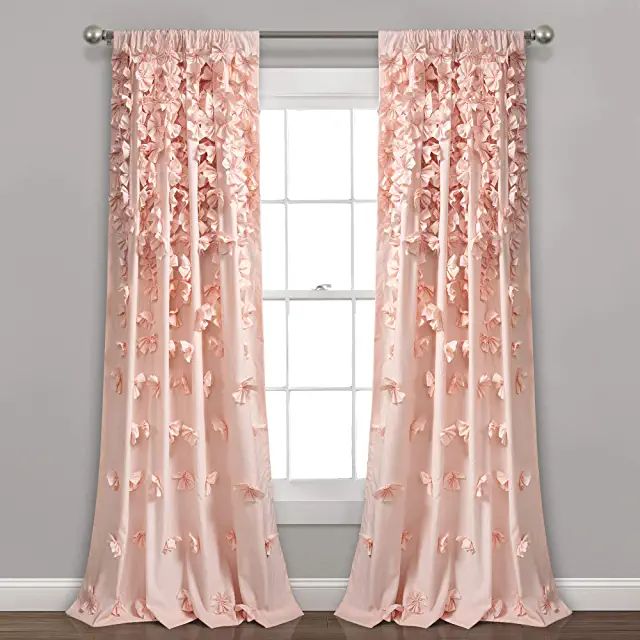 a pink curtain with flowers on it in front of a window