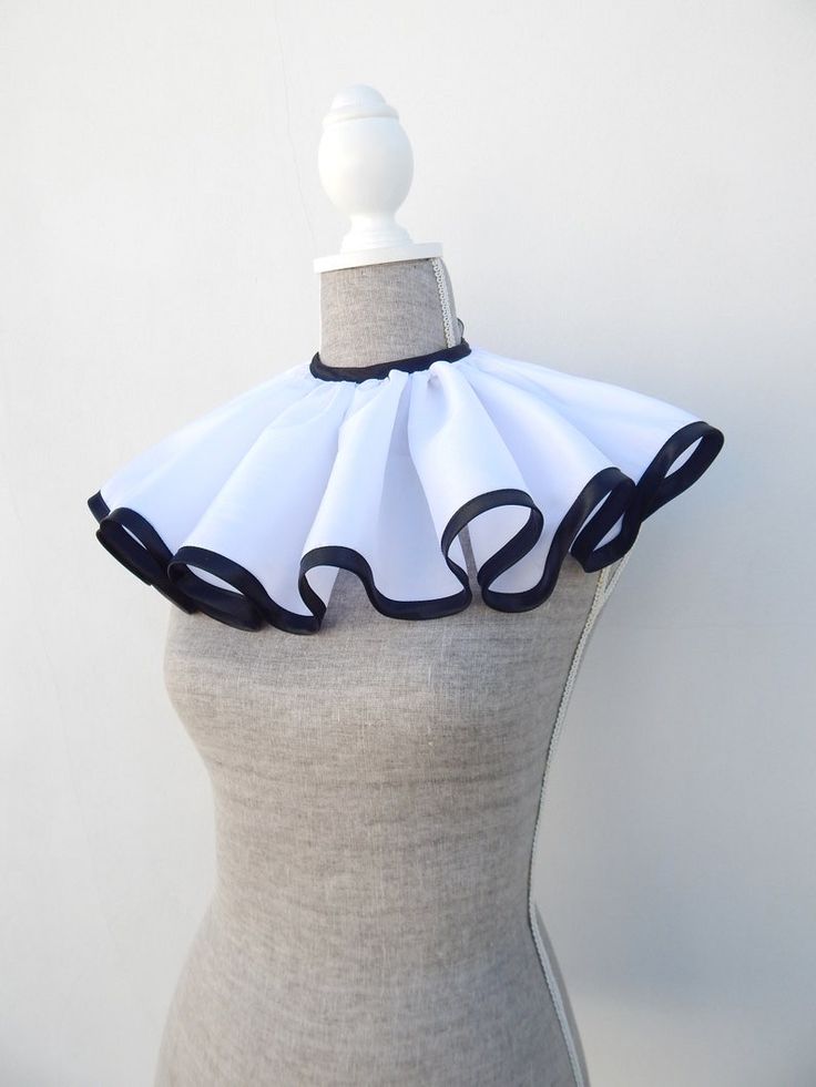 a mannequin wearing a white and black dress with ruffles on it