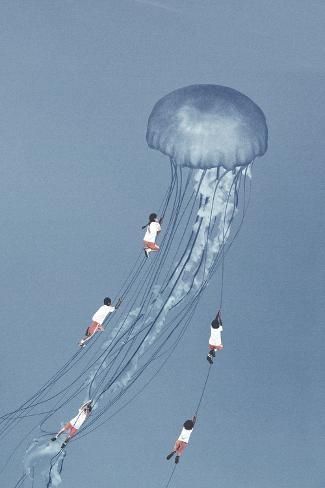 several people are flying in the sky with a jellyfish