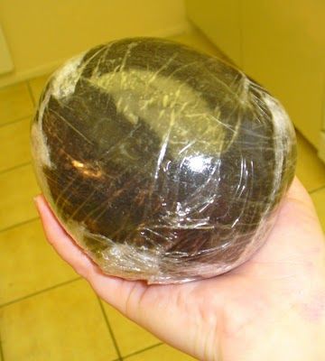 a person holding an object wrapped in plastic