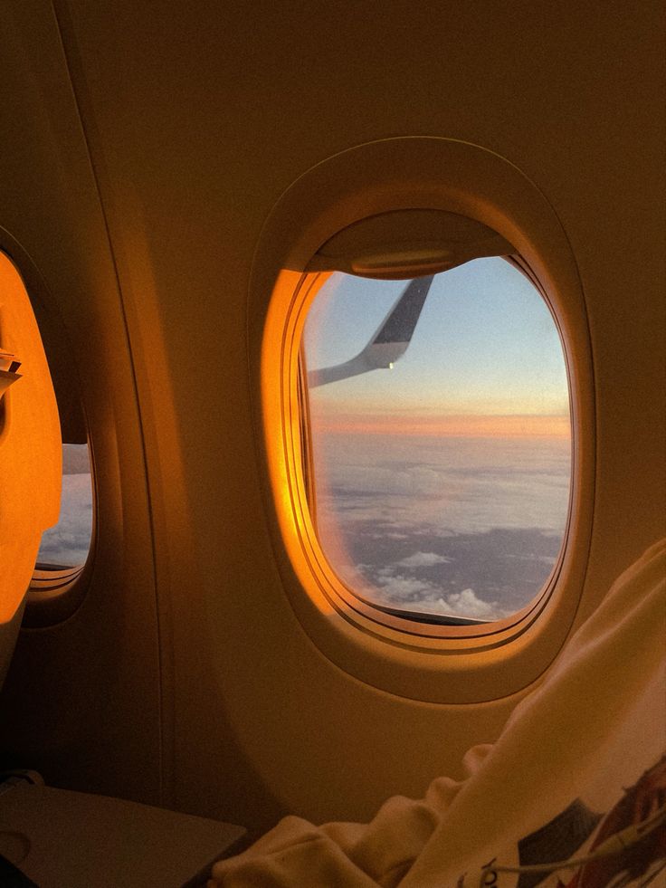 an airplane window looking out at the clouds