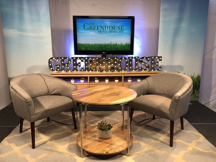 three chairs and a table in front of a television set with the words greenhouse on it