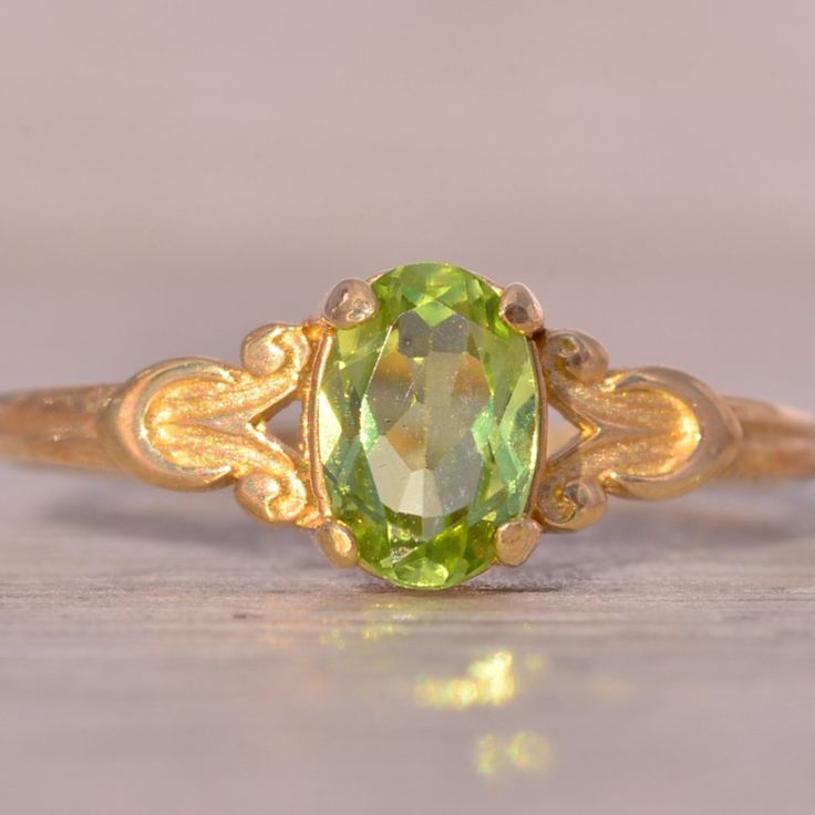 The Hove: Peridot Ring In Yellow Gold With Patterned Shank. This Delicate Ring Centers On An Oval Brilliant-Cut Natural Peridot With A Patterned Shank. The Ring Is Crafted In 14 Karat Yellow Gold And Is Currently A Finger Size 4.25 Yet Can Be Adjusted To Any Finger Size For An Additional Charge On Request. Yellow Peridot Wedding Jewelry, Yellow Peridot Wedding Rings, Peridot Engagement Rings, Green Gemstone Ring, Green Rings, Peridot Ring, Green Gemstones, Delicate Rings, Emerald Ring