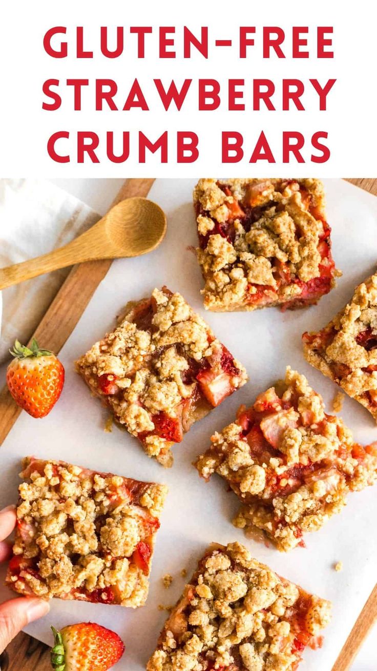 strawberry crumbler bars on a cutting board with strawberries in the foreground