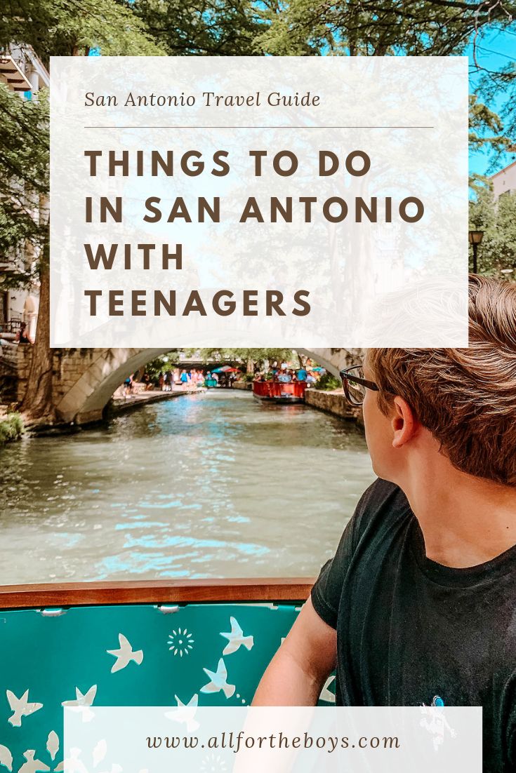 a boy sitting on a boat looking at the water and bridge in san antonio with text overlay reading things to do in san antonio with teenagers