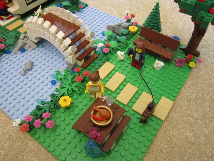 a lego park with flowers and trees on the ground