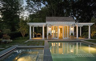 an outdoor pool and gazebo lit up at night