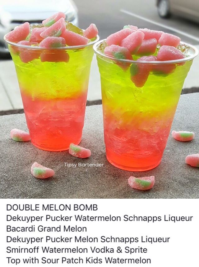 two glasses filled with jelly beans sitting on top of a table