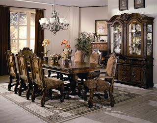 a dining room table with chairs and a china cabinet in the corner next to it