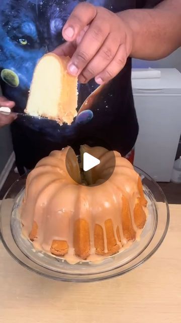 a person cutting into a bundt cake on top of a glass plate with a knife