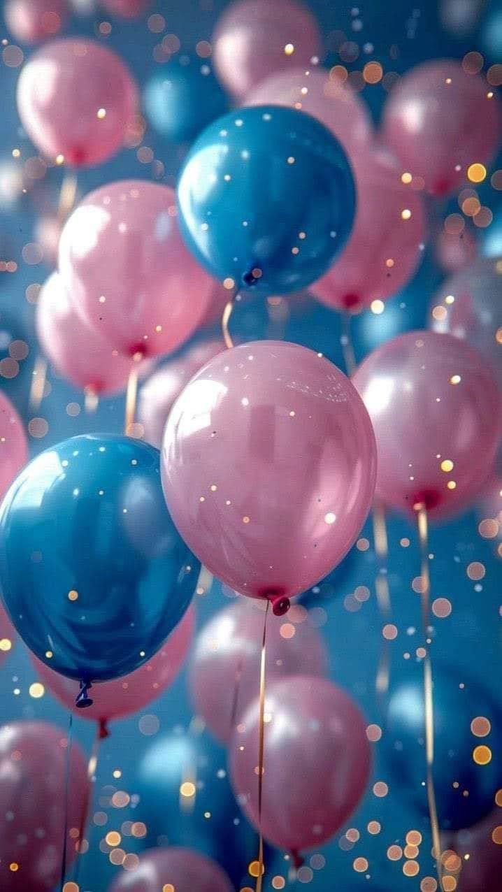 blue and pink balloons floating in the air