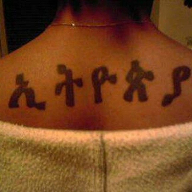 the back of a woman's neck with chinese characters on it