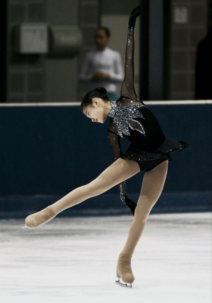 a female figure skating on an ice rink