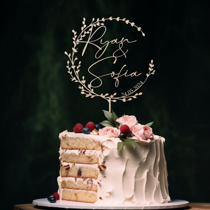 a wedding cake with white frosting and berries on top, sitting on a wooden table