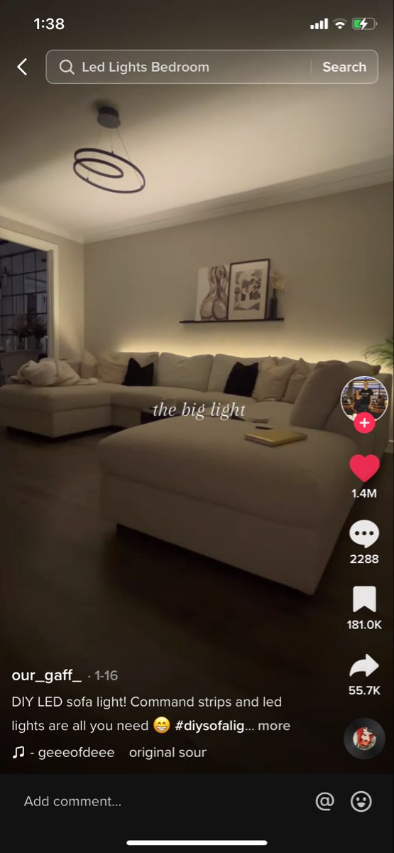 an image of a living room with lights on the ceiling and couches in the background