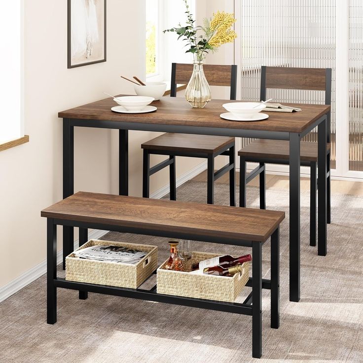 a dining room table and chairs with baskets under the table next to it on carpeted flooring