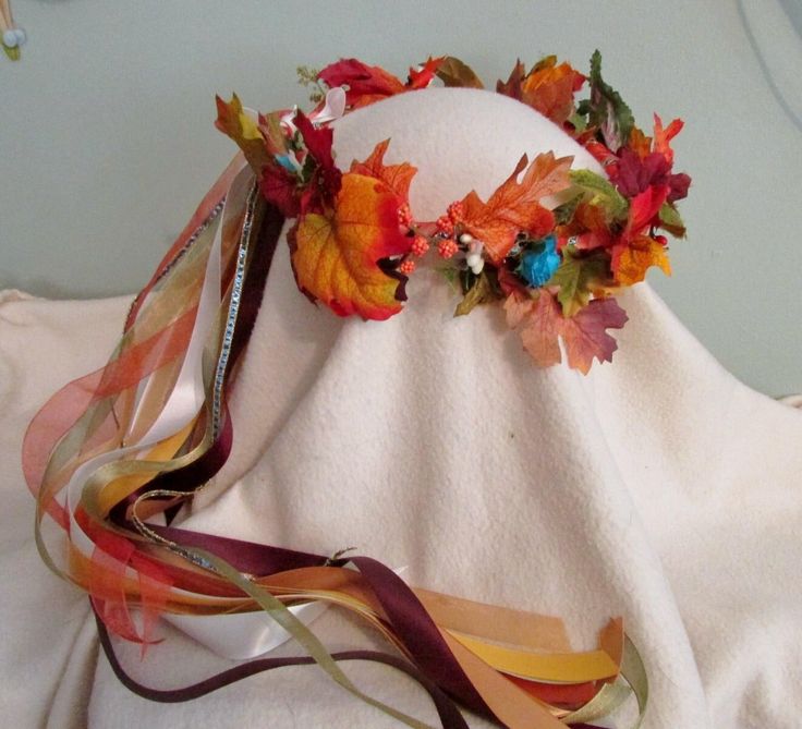 Beautiful, autumn colored fall leaves and faux berries, with just a few little turquoise blue flowers. Especially ideal for an autumn Renaissance wedding, and faires.  The long ribbons are beautiful autumn hues, brightened with antique white satin ribbon, delicate narrow sparkly blue and gold ribbons. The beautiful ribbons are a combination of satin and sheer, ivory, cream light sage green and gold. Please note that you are ordering a wreath that will be made after you order it, this allows me to make a custom designed wreath for you. You can have your wreath made to look just like the wreath in the picture, or you can have changes made to better reflect the colors and style of your event or outfit.    Most changes are done free of additional charge, however, there may be an additional cha Fall Crown, Sage Green And Gold, Fall Flower Crown, Flower Head Wreaths, Fall Headbands, Leaf Headpiece, Light Sage Green, Head Wreath, Special Pictures