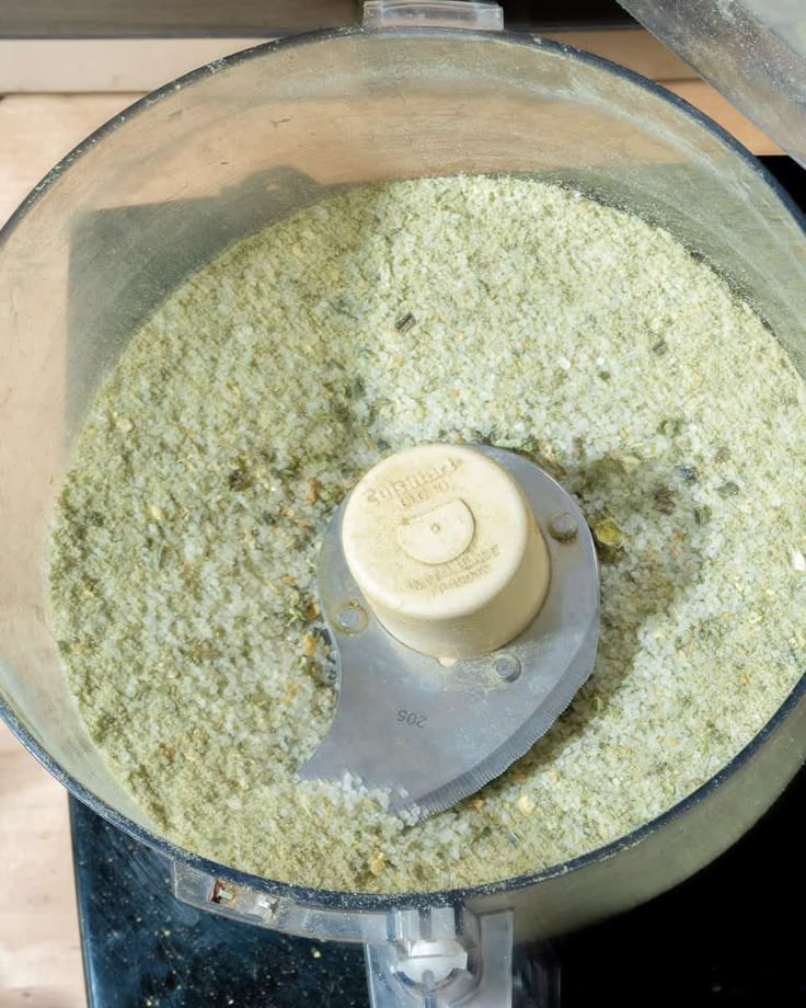 a food processor filled with lots of green stuff