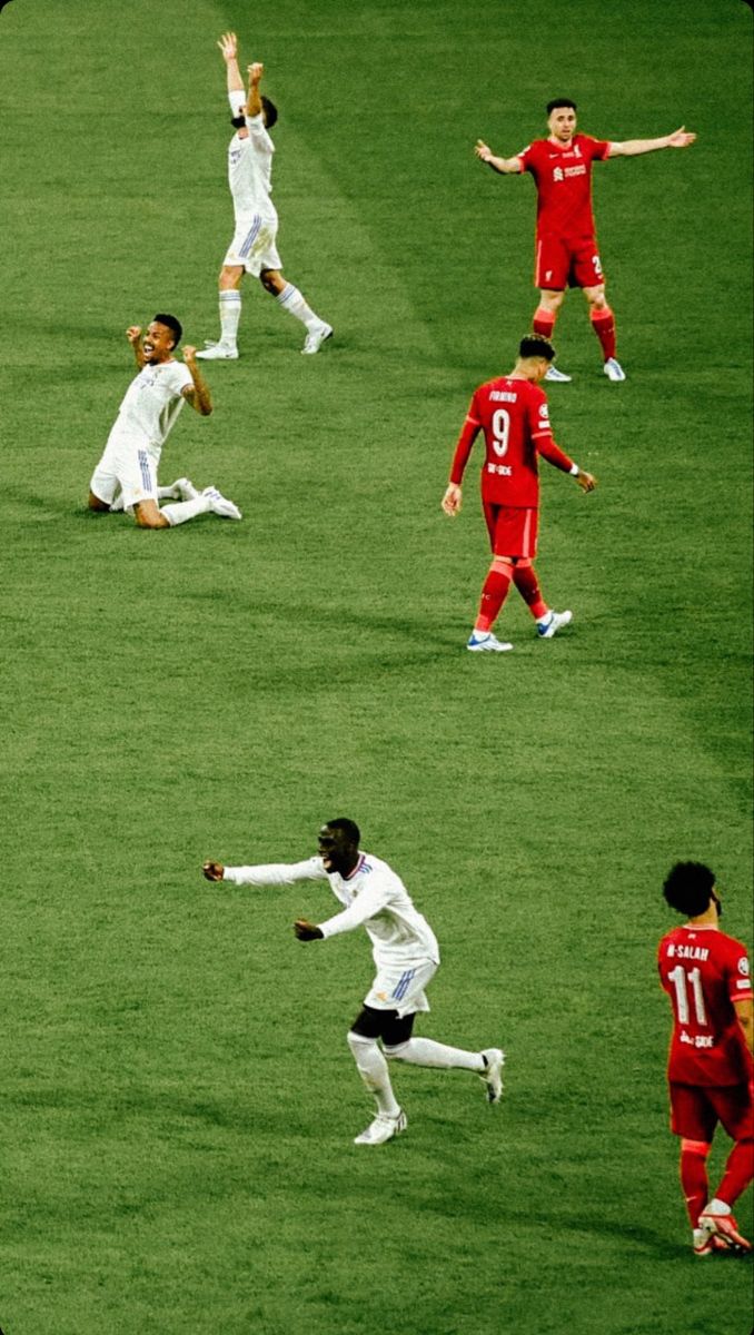 the soccer players are playing on the field in their uniforms and number one is celebrating