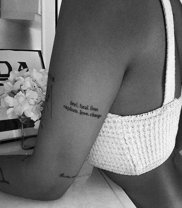 a woman with a tattoo on her arm that reads, i am real love everything else has changed