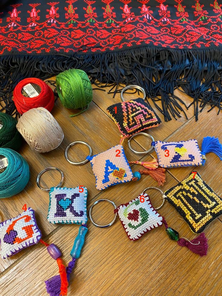 several different items are laid out on the floor next to each other, including balls of yarn and crochet hooks