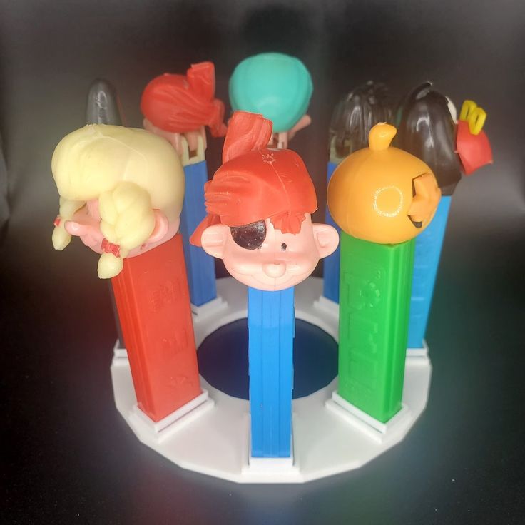 there are some plastic toys in the shape of people and animals on top of each other