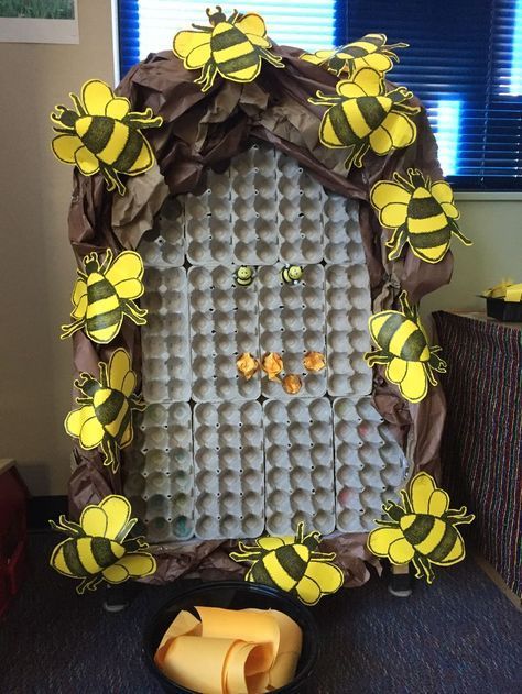 a photo frame made out of eggs in the shape of a beehive and bees