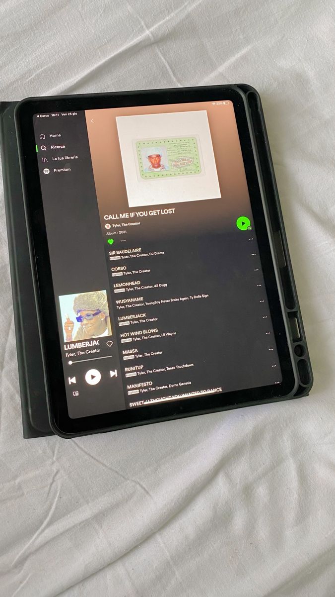 an open tablet computer sitting on top of a bed