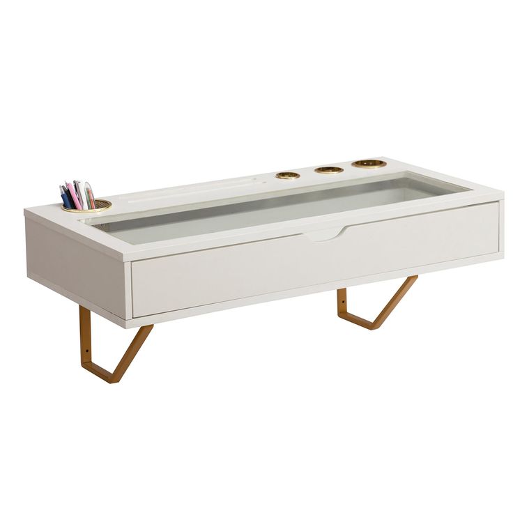 a white coffee table with gold legs and drawers