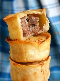 three pastries stacked on top of each other in front of a blue and white checkered background