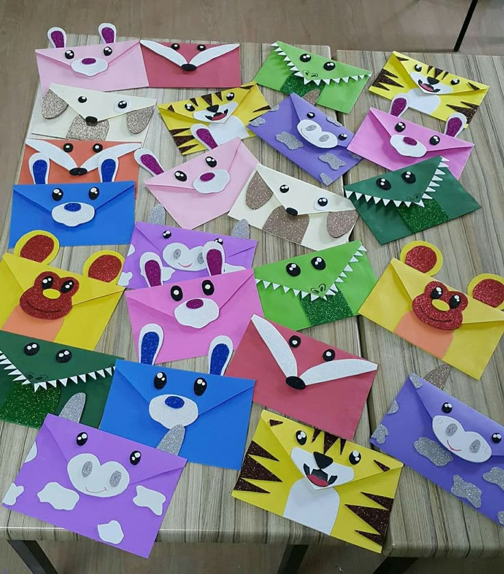 many different colored paper animals on a table