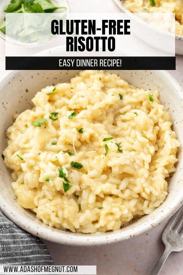 two white bowls filled with risotto and garnished with parsley on the side