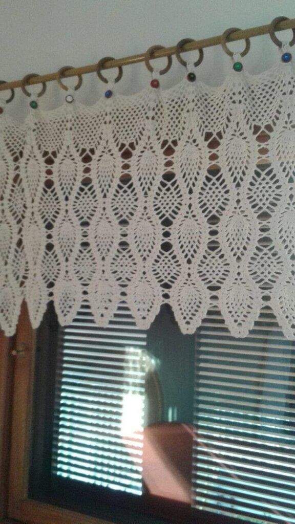 the curtain is made with white crochet