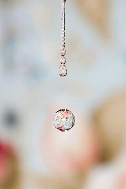 water drops from a faucet in front of a woman's face