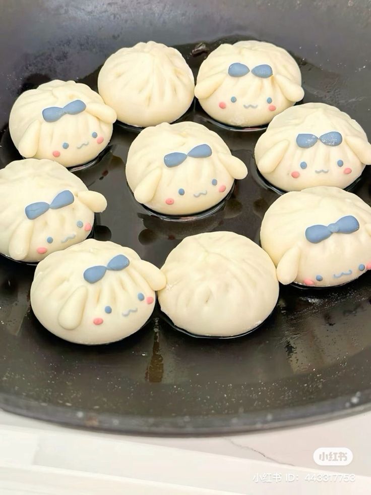 some dumplings are sitting in a pan on the stove top and ready to be cooked