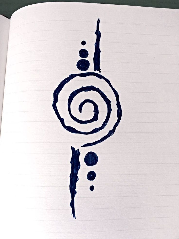 an open notebook with black ink on it and a spiral drawn in the middle,