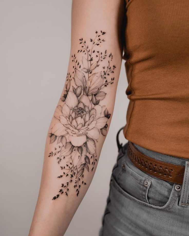 a woman with a flower tattoo on her arm