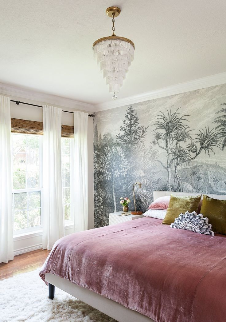 a bedroom with a bed, chandelier and wallpaper on the walls is shown