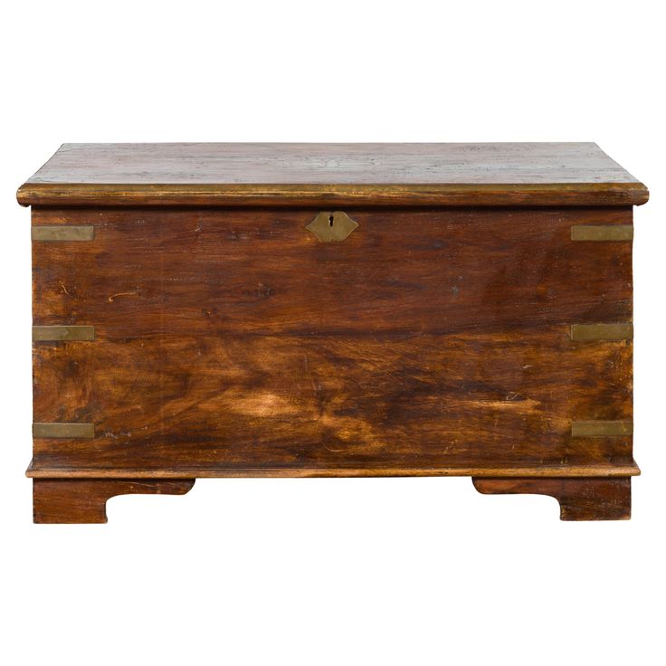 an old wooden chest with brass hardware on the top and bottom, against a white background