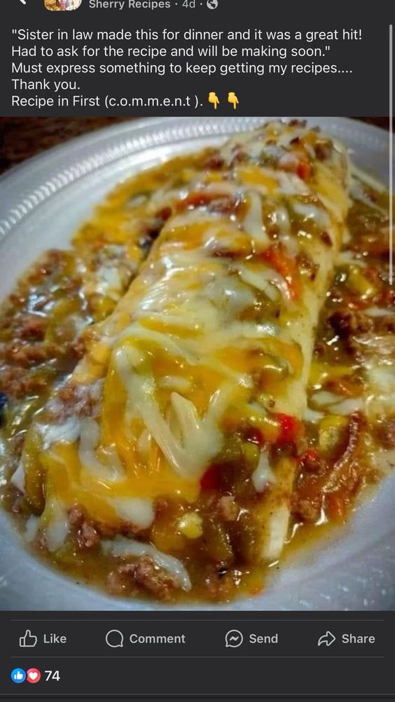 a white plate topped with cheese covered enchiladas