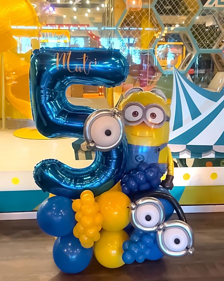 the number five balloon is made to look like a minion with glasses on it