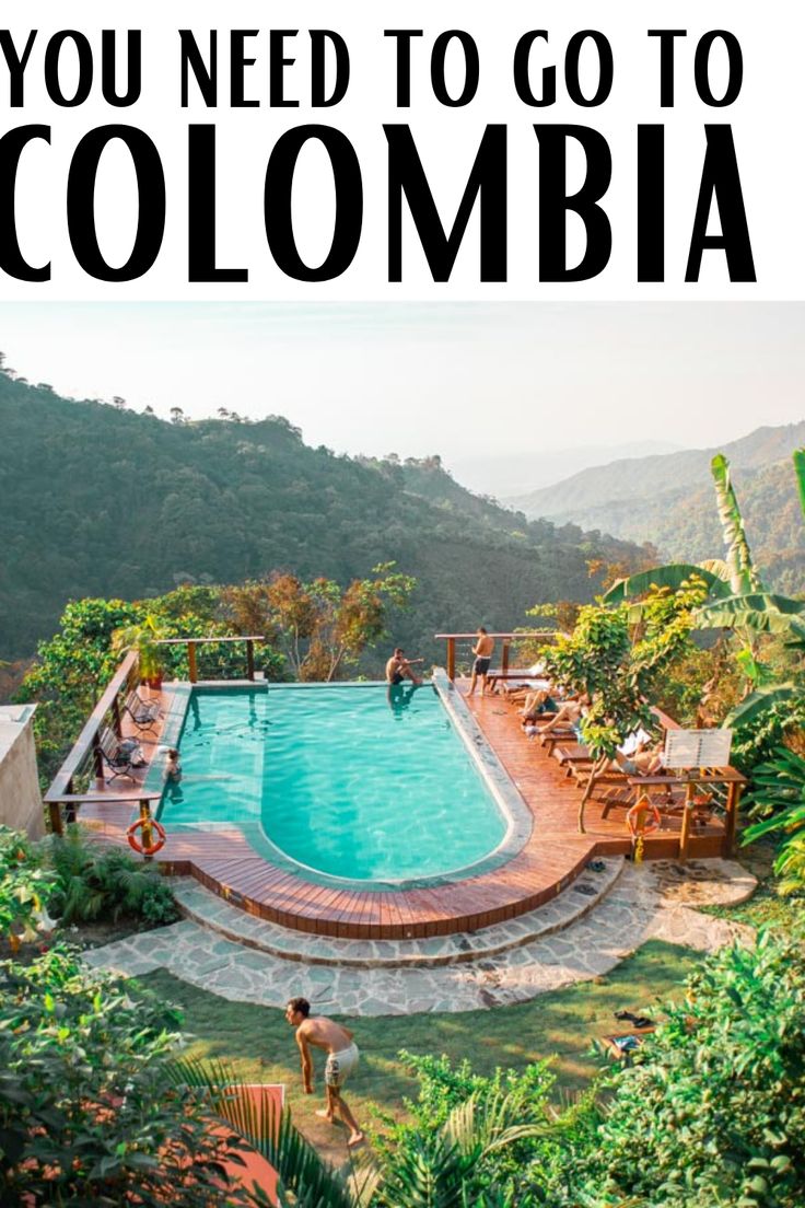 an outdoor swimming pool surrounded by greenery with the words, you need to go to colombia