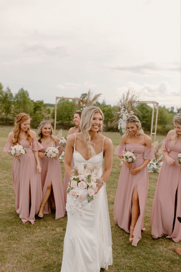 a bride and her bridesmaids in pink dresses