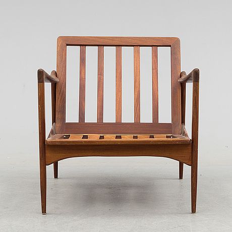 a wooden chair sitting on top of a white floor