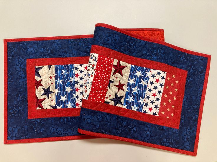 two red, white and blue quilted placemats on top of each other