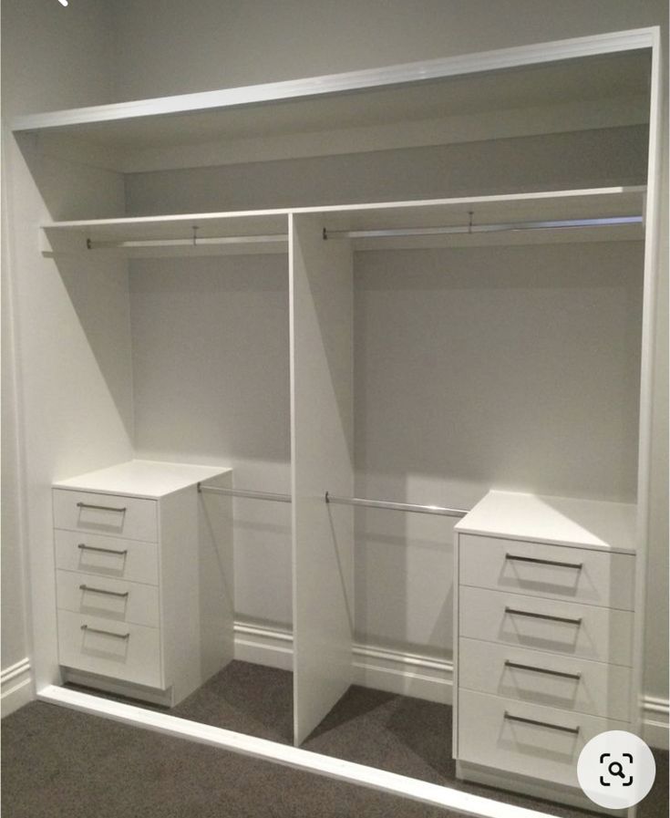 an empty white closet with drawers and shelves