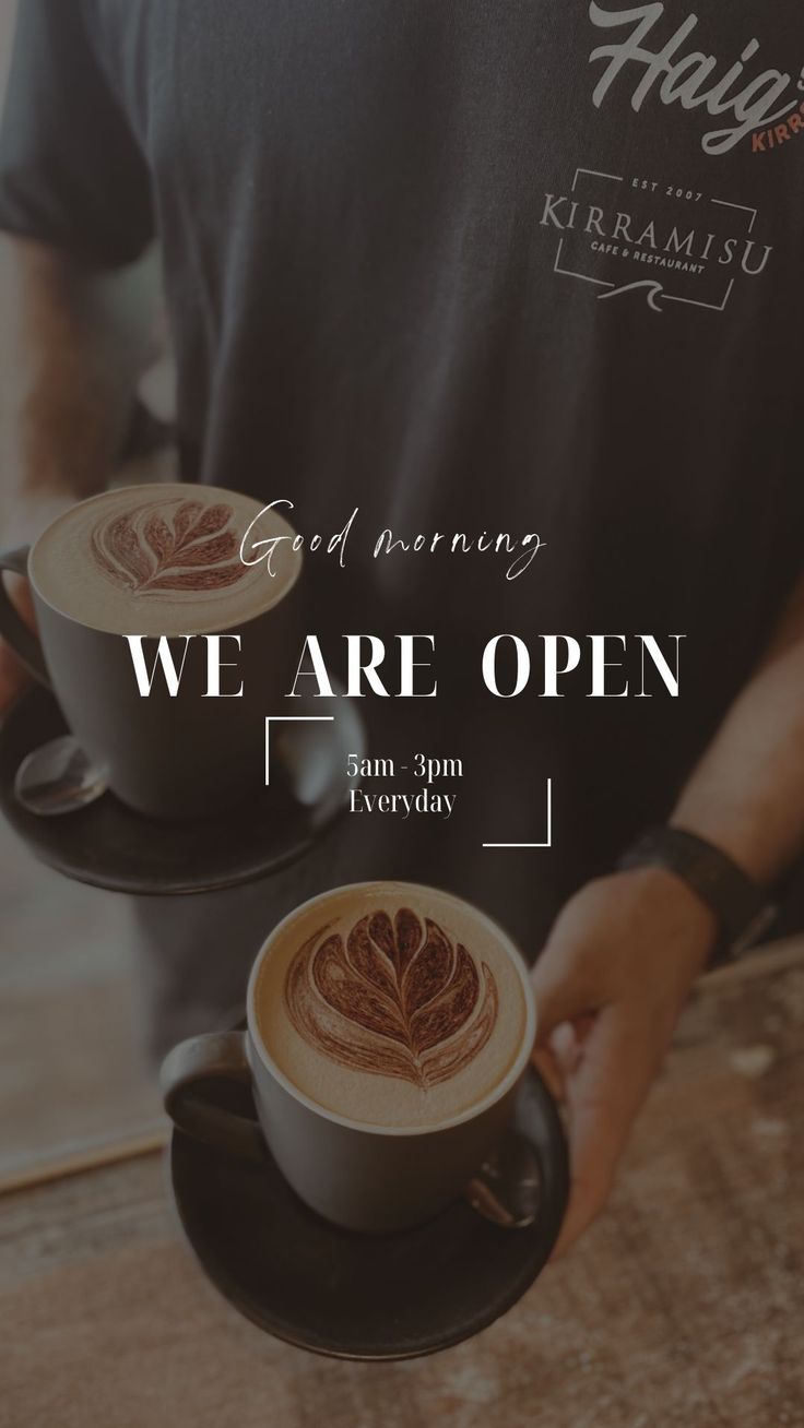 a man holding two cups of coffee with the words we are open