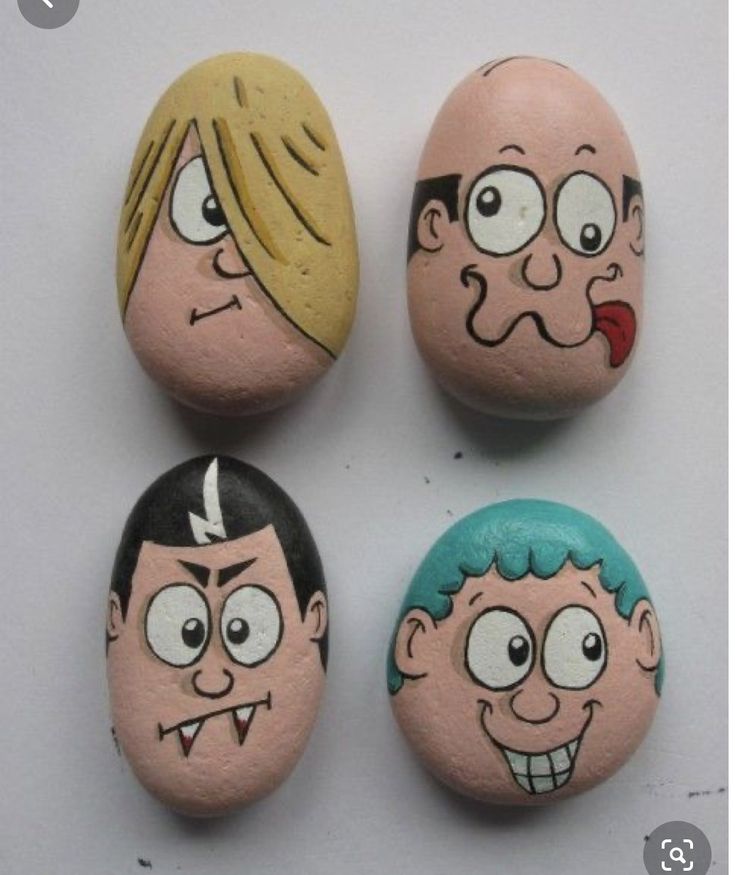 four painted rocks with cartoon faces on them