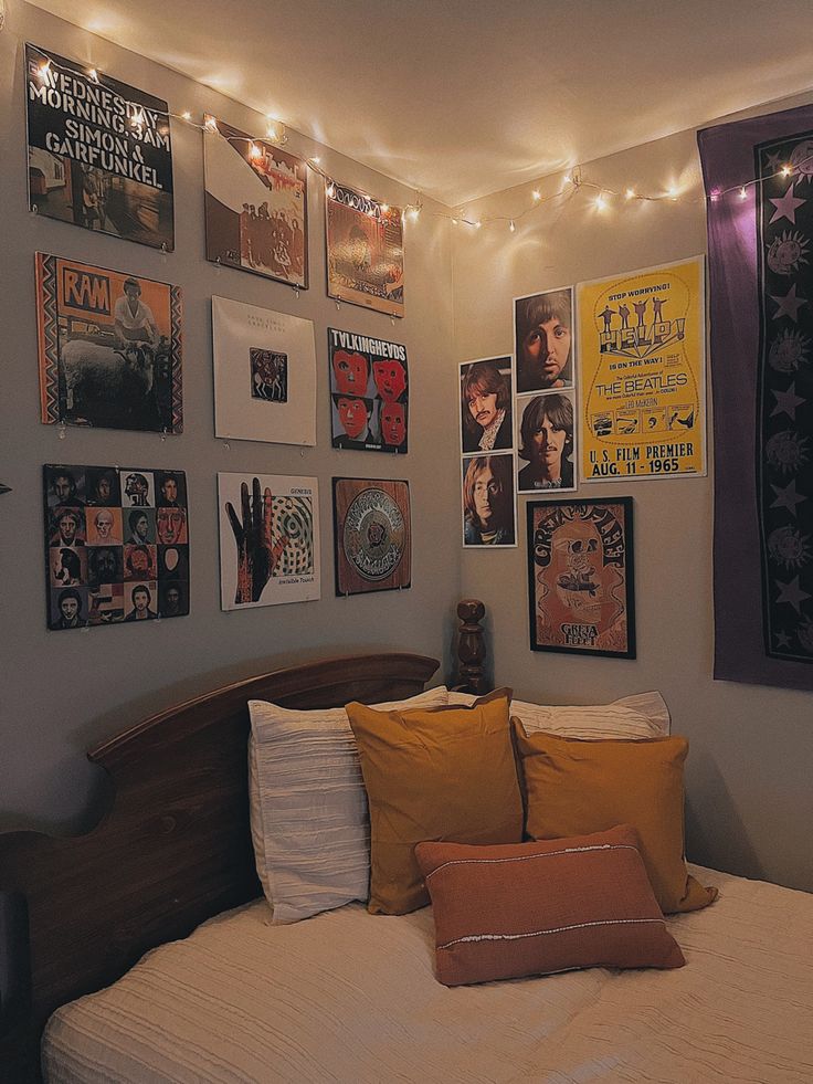 a bedroom decorated with posters and lights